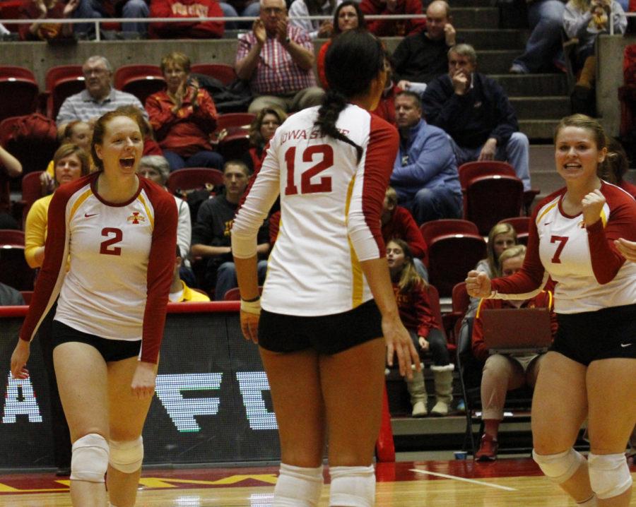 Teammates Mackenzie Bigbee, Tory Knuth and Caitlin Nolan celebrate a point during the Cyclones sweep of TCU on October 26.