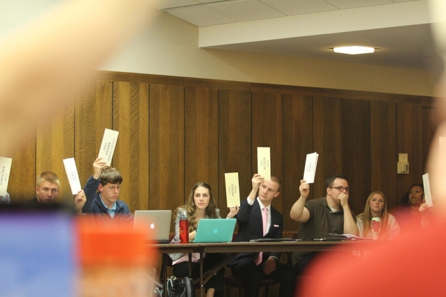 Senators raise their placards in a vote during Student Government Wednesday. 
