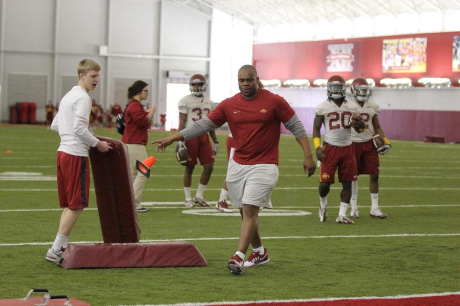 Running backs coach Louis Ayeni leads drills during spring practice on March 10 at Bergstom Football Complex. 