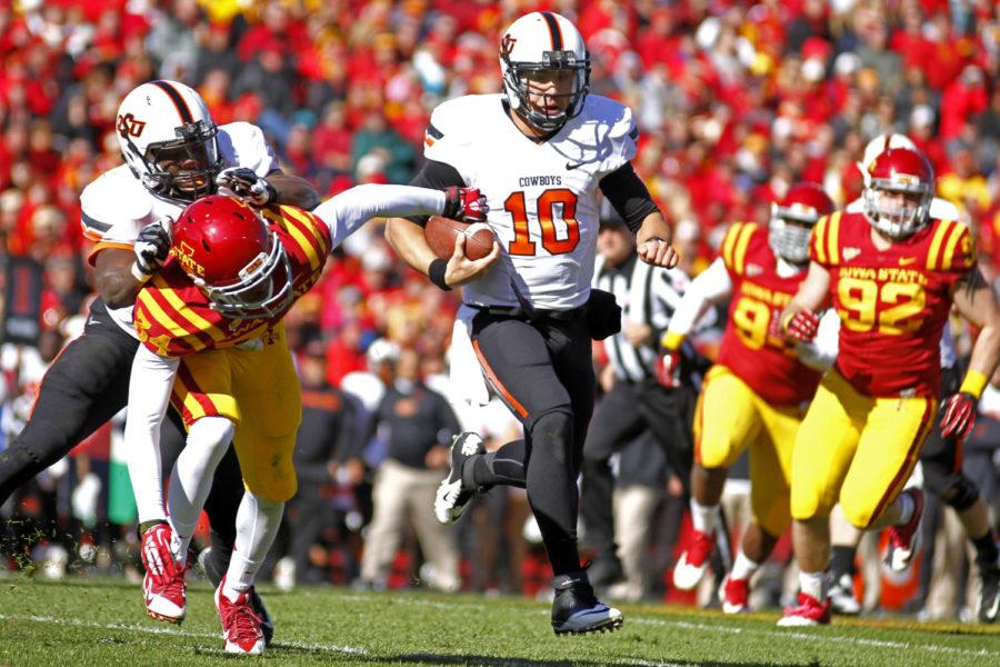 OSU senior quarterback Clint Chelf scrambles for a first down during Oklahoma States 58-27 win over Iowa State on Saturday, Oct. 26, at Jack Trice Stadium. Chelf had 92 yards on the ground on nine carries.