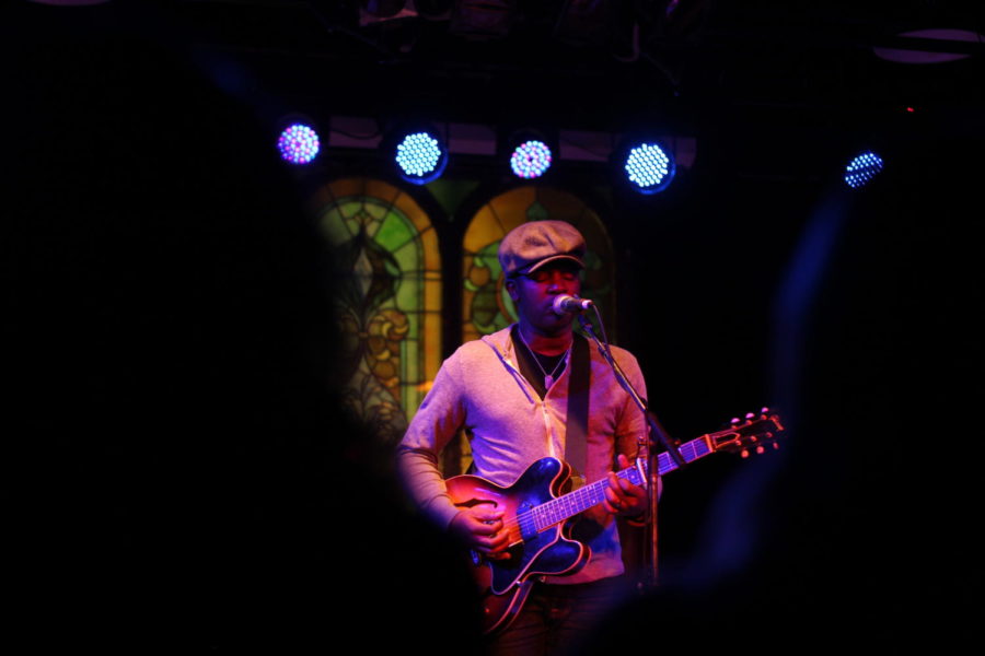 David Ryan Harris plays guitar at the Maintenance Shop Thursday night.  