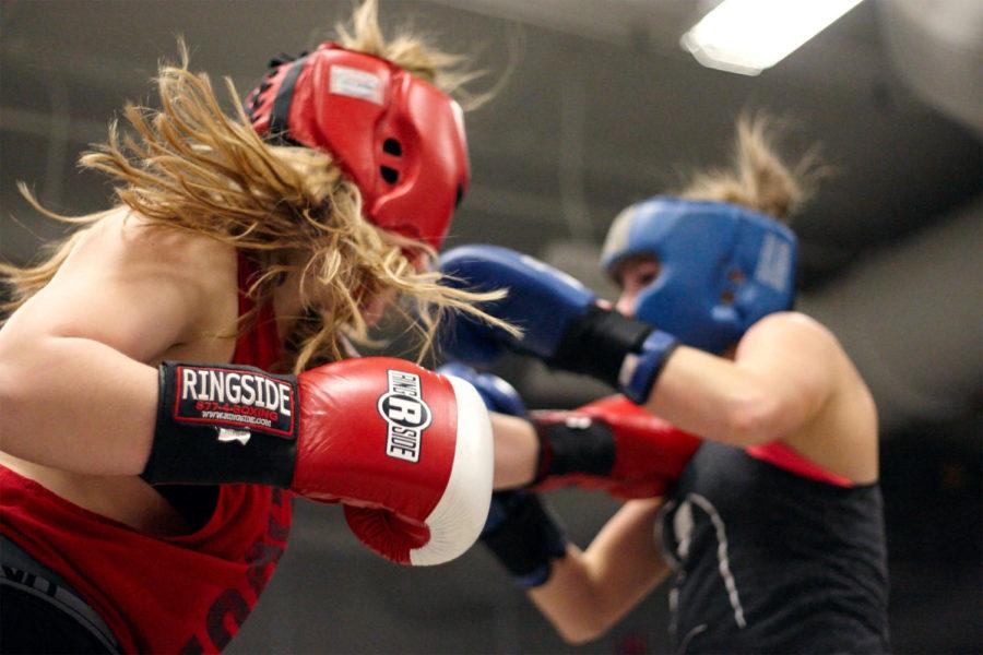 Student in Kinesiology Holly Adkins lands a punch on Paige Field, who is studying Animal Ecology.