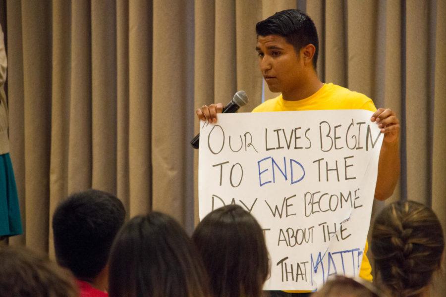 Jovani Rubio, senior in mechanical engineering, holds up a sign with a quote from Martin Luther King, Jr. during a multicultural open forum Sept. 14. The sign was ripped by a woman Saturday during protest against Donald Trump. 