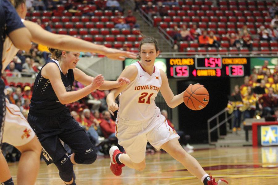 Bridget+Carleton%2C+freshman+guard%2C+passes+opponents+on+the+court+at+the+second+exhibition+game+Nov.+8.