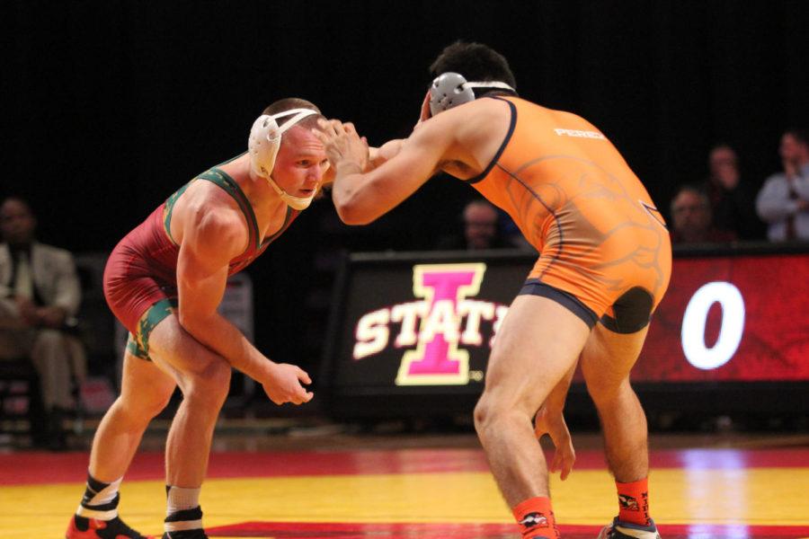 Kyle Larson, redshirt junior, faces an opponent at the match against Midland University on Nov. 12 at Hilton Coliseum.
