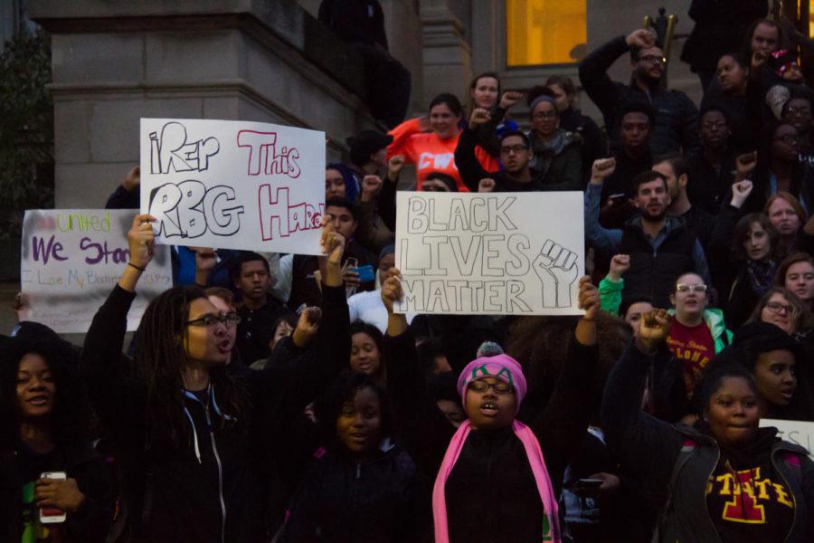 Students hold signs saying "iRep this RBG hard" and "Black lives matter" and chant. Students, staff and community members meet for a rally in Beardshear Hall Monday evening. The rally was to show solidarity with the students protesting racism at Mizzou, and called for action and reform from the ISU administration.