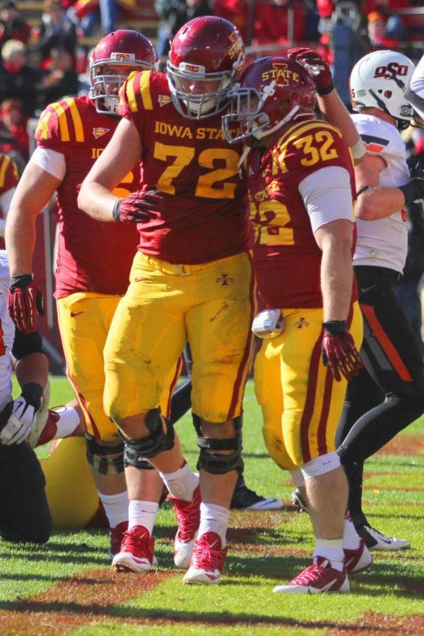 Redshirt sophomore Brock Dagel congratulates redshirt senior Jeff Woody after Woodys fourth quarter touchdown on Saturday, Oct. 26. Iowa State lost to Oklahoma State 58-27.