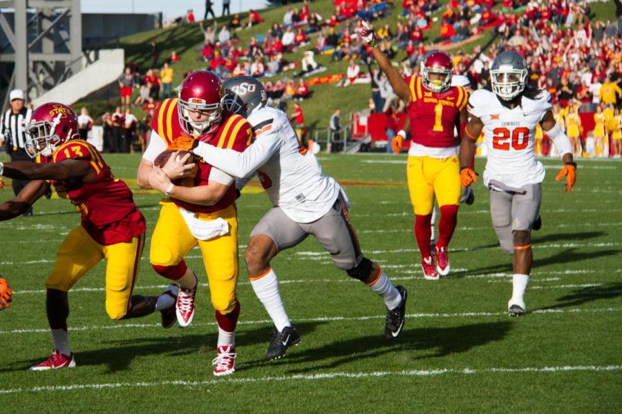 Sophomore quarterback Joel Lanning breaks a tackle during the game against Oklahoma State University on Saturday, Nov. 14. The Cyclones would go on to lose 31-35.  