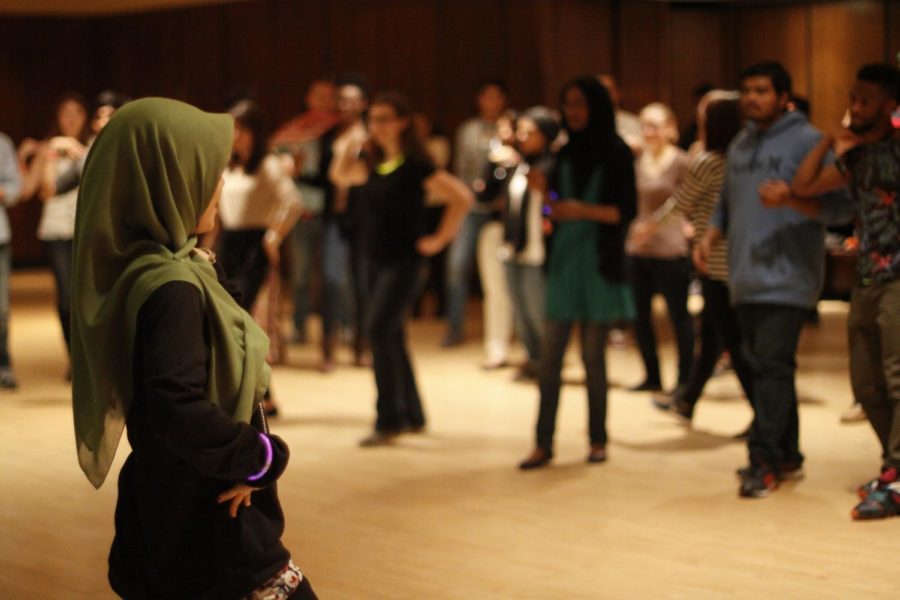 Students from the Malaysian Student Association work together in leading the participants in a Malaysian dance on Friday night. The dance night was part of International Week held by the International Student Council.