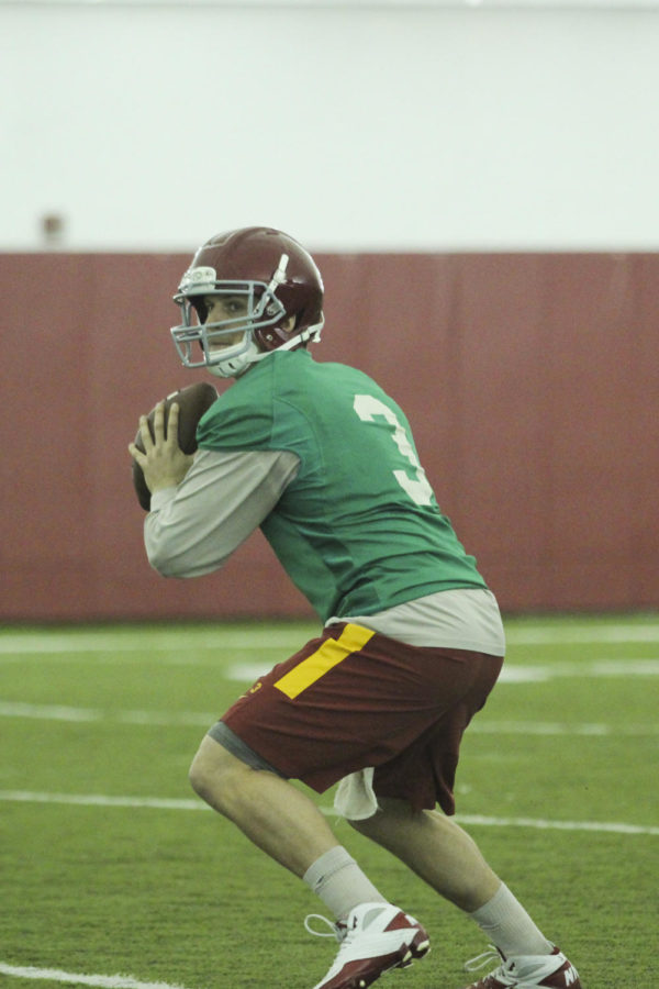 Redshirt junior quarterback Grant Rohach passes the ball at the first football practice March 3 at Bergstrom Indoor Practice Facility.