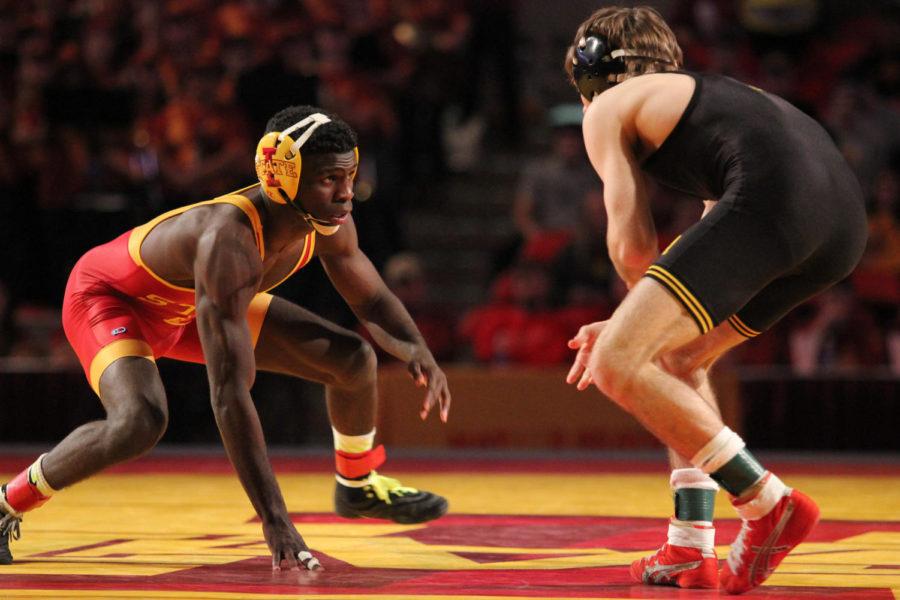 Earl Hall, senior, faces an opponent from University of Iowa at the Iowa Corn Cy-Hawk Series match Nov. 29 at Hilton Coliseum.