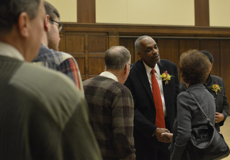 Tom Hill, senior vice president for student affairs, greets visitors to his retirement ceremony on Dec. 14 at the Sun Room.