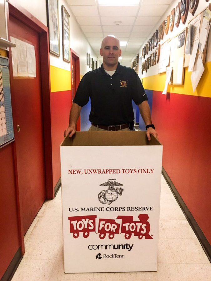 GySgt Christopher Harrison with the collection box. The box is used for collecting toys for Toys For Tots.