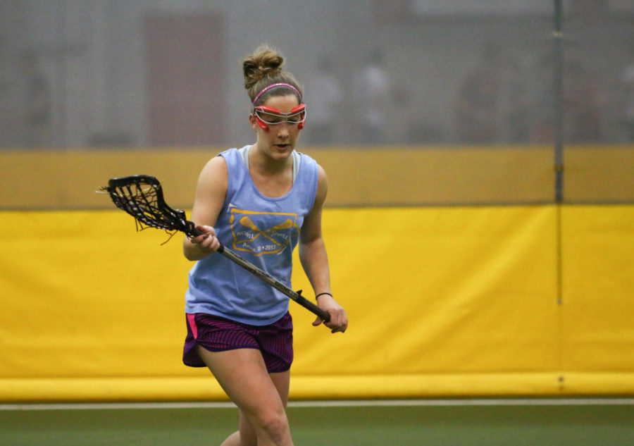 Jessica Koeger, senior in mechanical engineering and president of the Womens Lacrosse Club, warms up during the last practice of the season at the Lied Rec Center.  