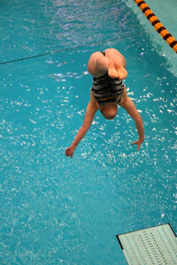 An Iowa State diver performs a dive. The Iowa State swim team hosted the annual Cy-Hawk swim meet at Beyer Hall Fri. night. The Hawkeyes would go on to win every event, contributing to the teams 190-93 win. 