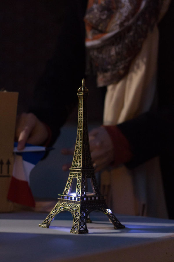 An Eiffel Tower figure sits on a table as part of a candlelight vigil Friday night. The vigil was in support all of those suffering in the wake of acts of hate and discrimination around the world, primarily highlighting the attacks in Paris, the Black Lives Matter movement and the refugee crisis. 