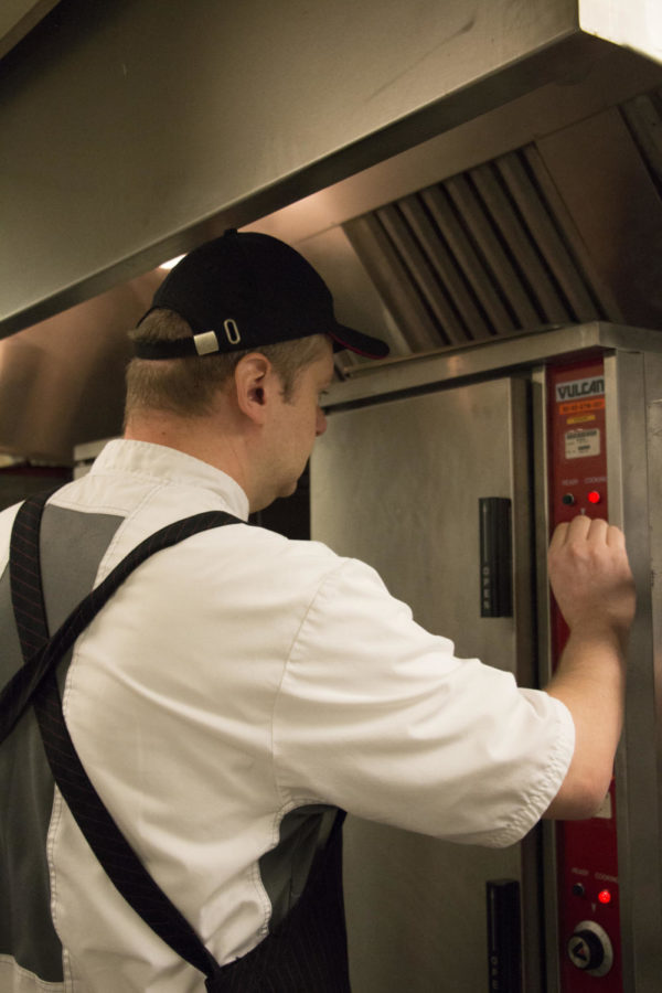 Executive Chef Scott Bruhn sets the temperature on a steamer at the Memorial Union Kitchen. Bruhn’s typical workday begins at 6 am, where he first works on administrative duties before going around to the different kitchens on campus where he checks in on food production.