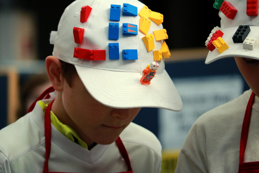 The Nuemanbots team at the FIRST LEGO League Tournament kept with the spirit of the event and dressed in lego themed costumes. Their hats, shoes and aprons were adorned with various legos and figurines. 