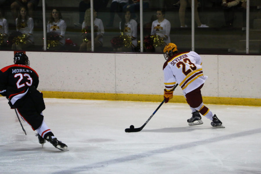 Forward Jon Severson, freshman, prepares to hit the puck during the game against Illinois State Friday night. The Cyclones beat the Redbirds 4-2.