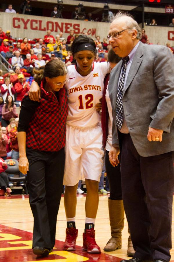 Iowa State junior Seanna Johnson is helped off the court after a knee injury Jan. 23 in Hilton Coliseum against the Baylor Bears. The Cyclones lost 77-61. 
