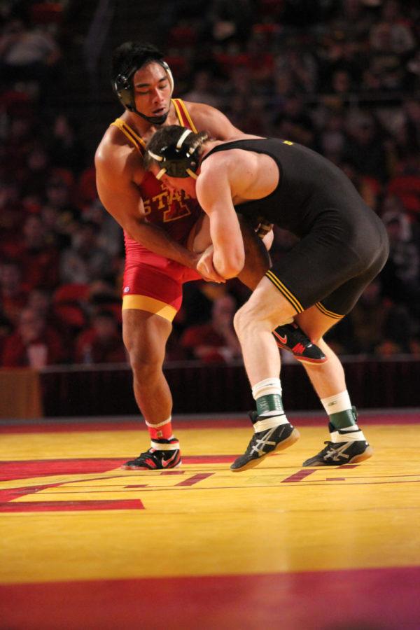 Dane Pestano, redshirt sophomore, wrestles an opponent from the University of Iowa in the Cy-Hawk wrestling match Nov. 29. Iowa State lost 33-6 at Hilton Coliseum.