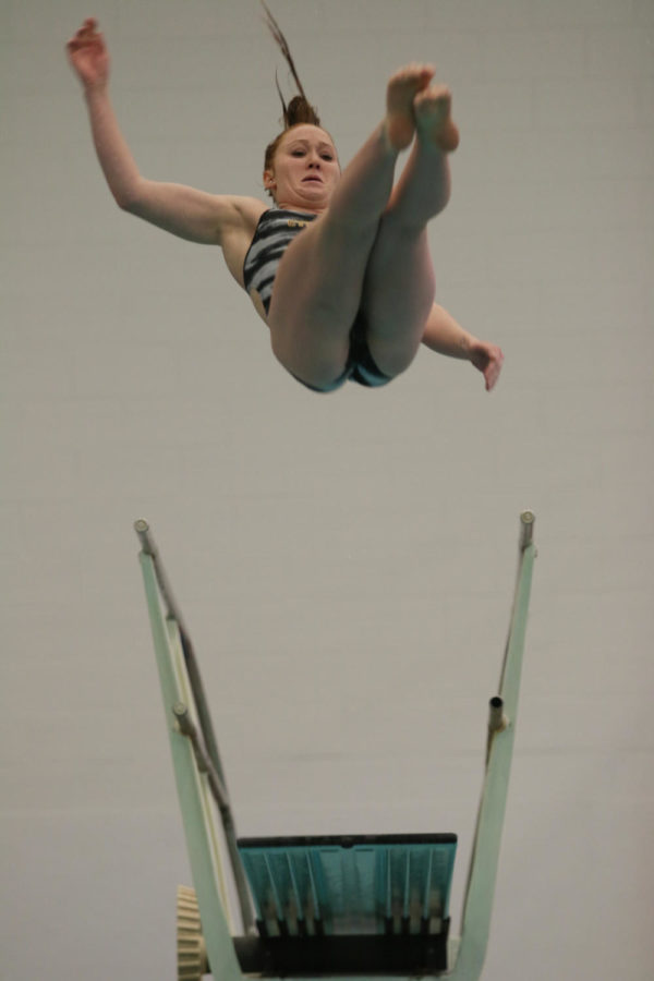 Becky Stochl, junior, performs a 1.5 somersault 1.5 twist dive during the meet against the University of Illinois Fri. night.