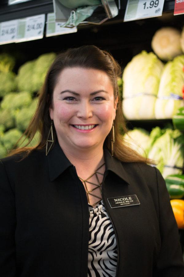 Nicole Arnold, a dietitian at the HyVee in West Ames, stands in front of the produce aisle. Arnold graduated from Michigan State University and has worked as a HyVee dietitian since April 2006. 