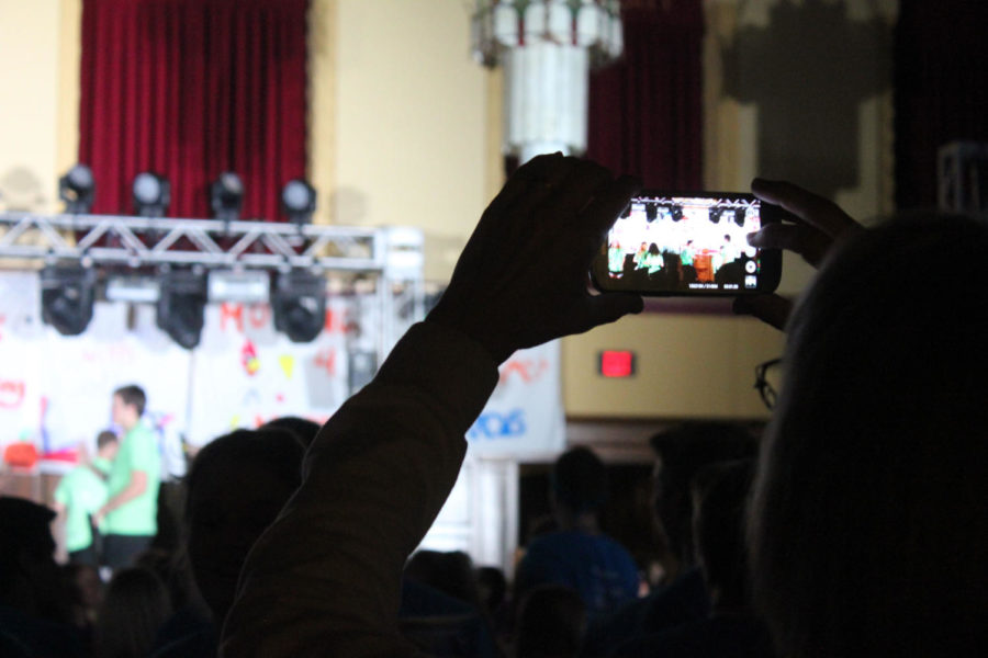 Many people capture the action of Dance Marathon on their cell phones.