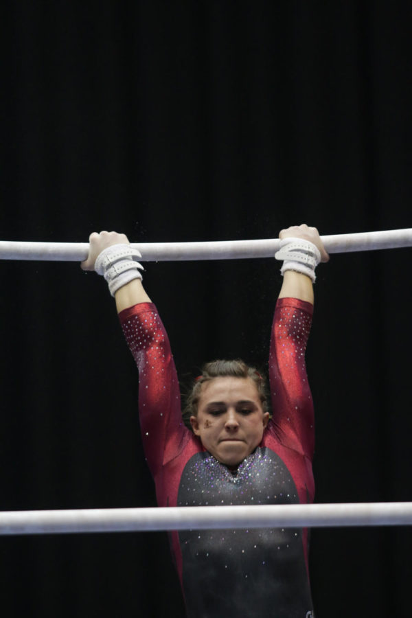 Meaghan Sievers, freshman, performs her uneven bars routine during the meet against Lindenwood and North Carolina State Jan. 23. Sievers would go on to score a 9.9, the second-highest score of the event. 