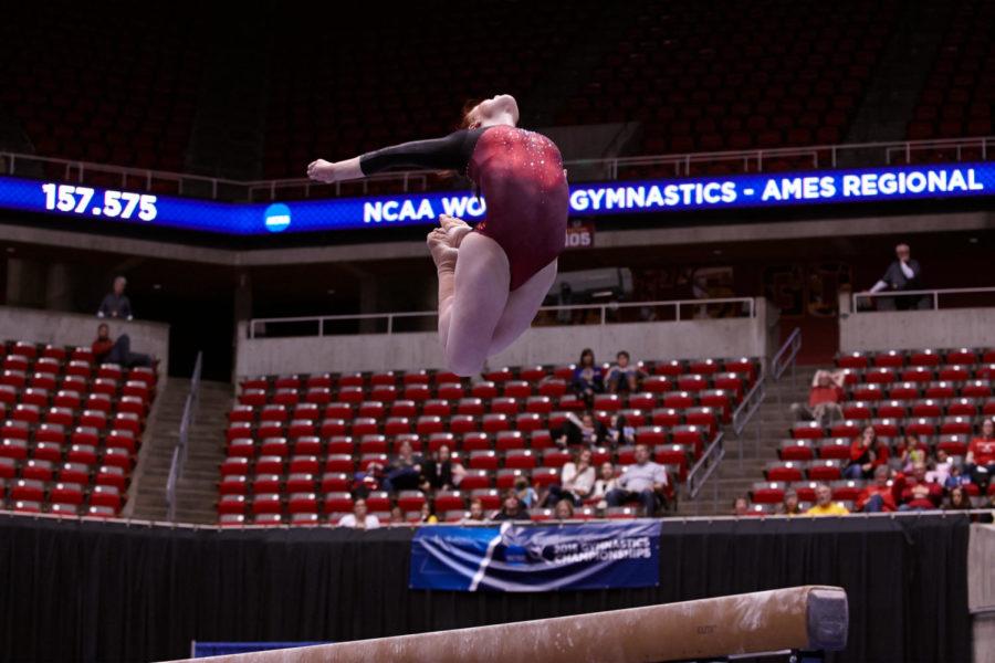 Sophomore Lark Pokladnik leaps off the beam during her routine at the NCAA Regionals on Saturday at Hilton Coliseum . Iowa State placed fifth.