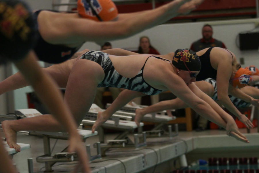 Swimmers dive off the block for the 100 breaststroke during the meet against the University of Illinois on Friday night. The Fighting Illini went on to defeat the Cyclones 164.5 to 135.5. 