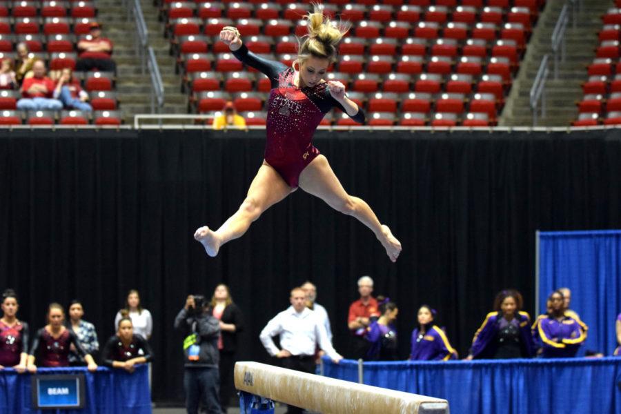 Junior Alex Marasco does a split jump while competing on the beam at the NCAA Regionals on Saturday at Hilton Coliseum.