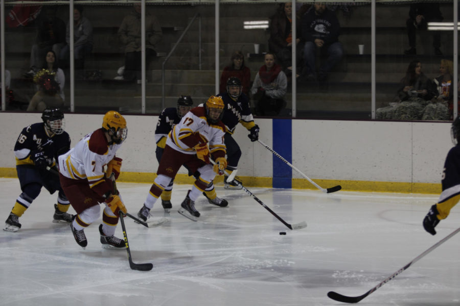 Freshman forward Aaron Azevedo and freshman forward Tony Uglem pass the puck against Augustana College during the game Oct. 30. The ending score was 11-0.