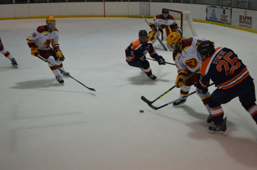 Iowa State competes against University of Illinois for the puck in a competitive defensive battle.