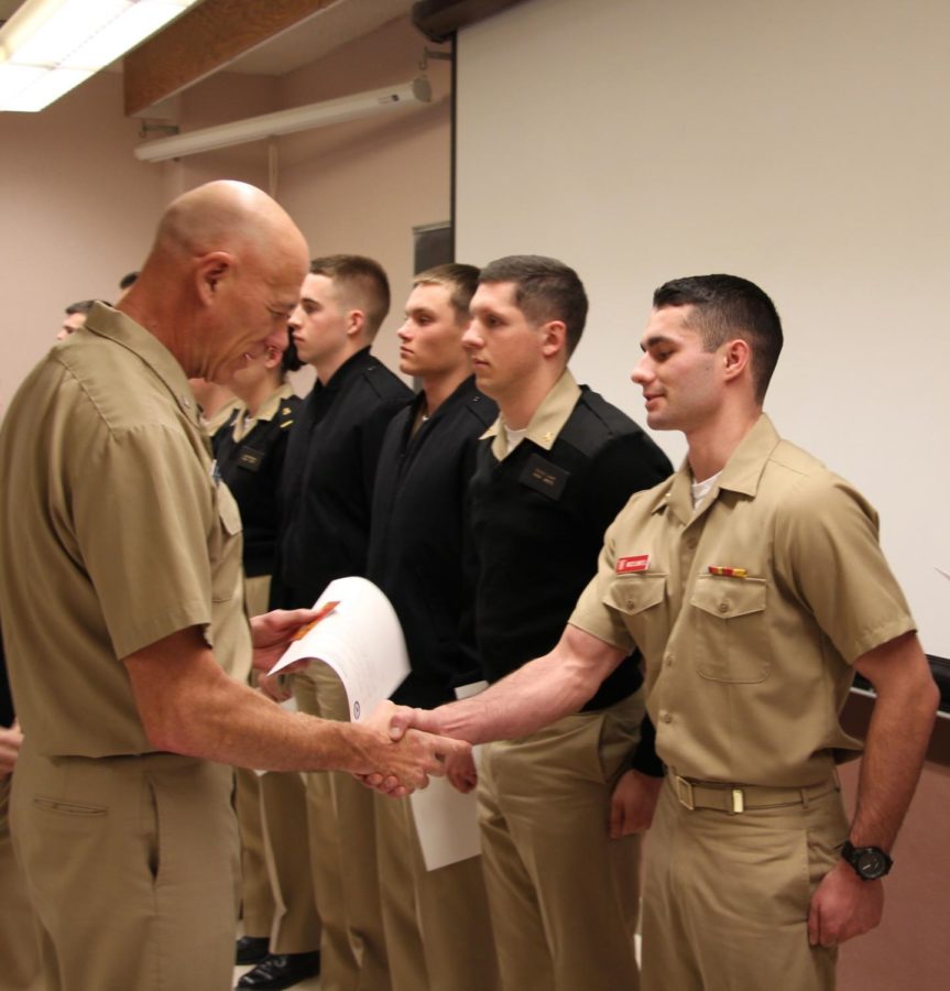 Capt. Ricks Polk hands out awards at a semester awards ceremony on Thursday afternoon. Midshipmen who earned the awards were recognized in their academic and physical achievements. 