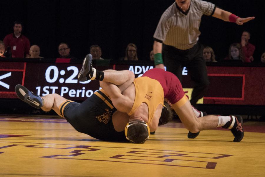 Flipping his opponent over onto his back, redshirt senior Tanner Weatherman goes in for a pin. Wrestling at 165 Weatherman pinned his West Virginia opponent, Connor Flynn, at 2:43.