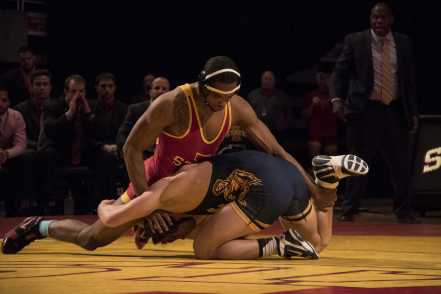 Redshirt junior Lelund Weatherspoon sprawls to maintain his advantage over West Virginias Ross Renzi. Wrestling at 165, Weatherspoon won the match with a pin and extended the Cyclone lead to 25-8. The Cyclones won the meet 28-11.