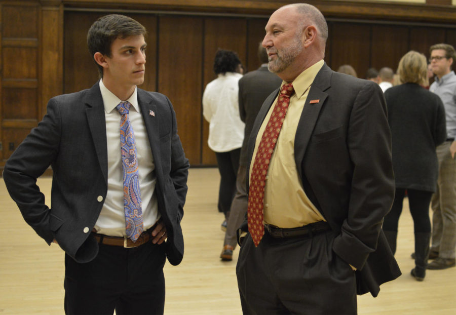 Steven Leath, president of Iowa State University, and Daniel Breitbarth, student government president, stand before Senior Vice President of Student Affairs Tom Hills retirement ceremony begins on Dec. 14 in the Sun Room.