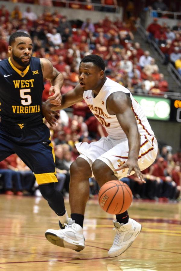 Redshirt junior guard Deonte Burton reaches for the basketball during the against West Virginia on Feb. 2 at Hilton Coliseum. The Cyclones lost 81-76.