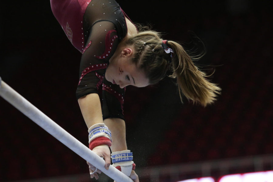 Sophomore Kelsey Paz performs her uneven bars routine during the quad meet at Hilton Coliseum. Iowa State played host to North Carolina State, Nebraska, and University of Wisconsin-La Crosse Feb. 21, and would go on to place third with a combined score of 194.9. 