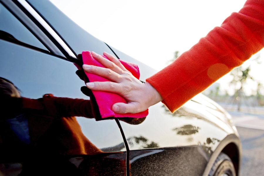Woman hand polishing her car.
