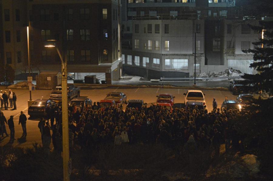 People gather outside of St. Johns church on Lincoln Way on Feb. 1 for the caucuses. Organizers estimated a turnout of 150 people. It was originally meant to be held inside the building but had to move to the parking lot.