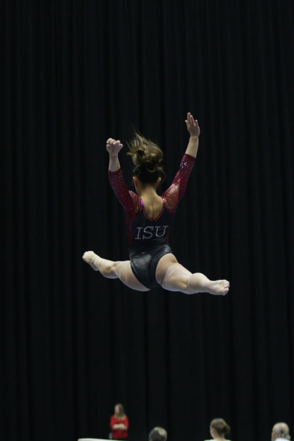 Sydney Converse, freshman, performs her balance beam routine during the meet against Lindenwood and North Carolina State Jan. 23. Converse would go on to earn a 9.65 for the event. 