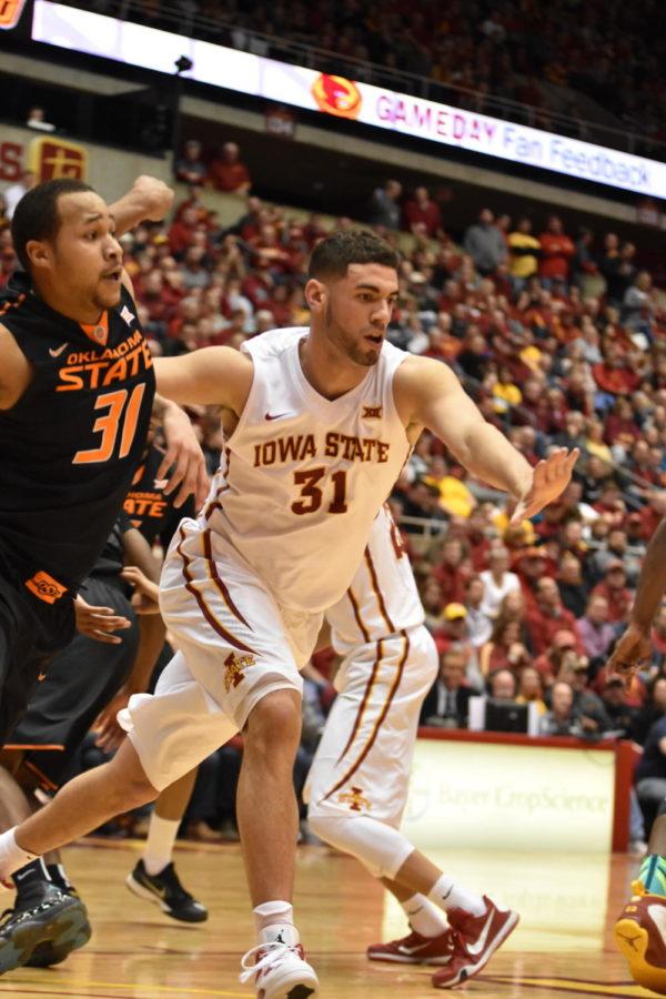 Senior forward Georges Niang blocks an opponent from Oklahoma State during the basketball game on Feb. 29. Niang was honored for the ISU Senior Night.