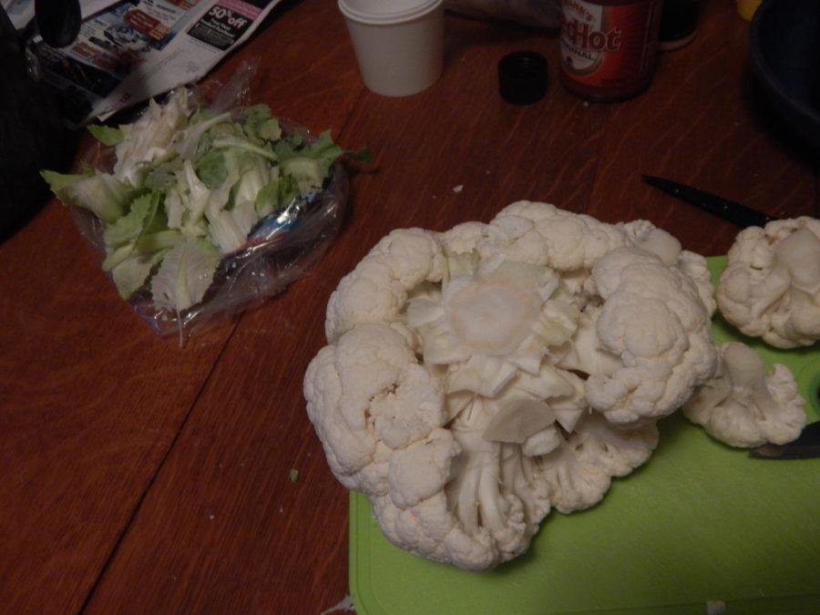 Step one is to remove the green base from the bundle of cauliflower florets.