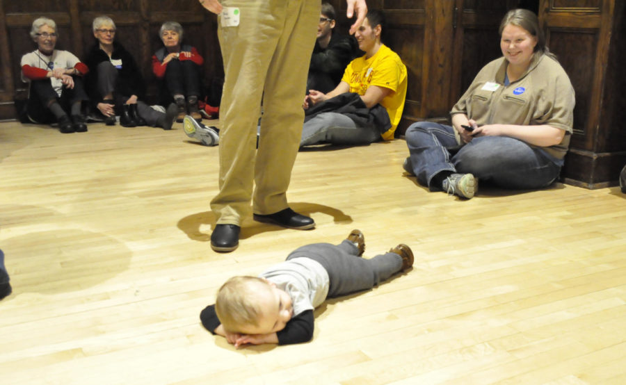 A young caucus-goer takes a break from running among supporters on the night of the caucus Feb. 1 in the Great Hall of the Memorial Union. 