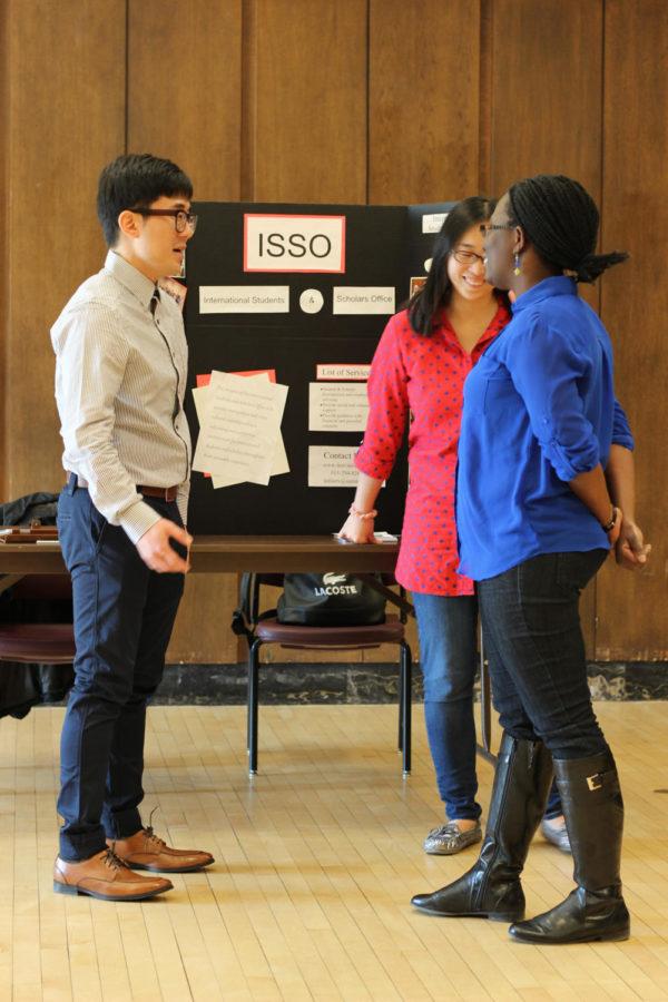 Graduate assistant Aja Holmes socializes with members of the International Student Scholars Office, during the Diversity Resource Fair in the Sun Room of the Memorial Union on March 26.