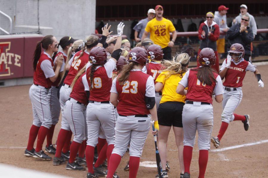 Junior outfielder Brittany Gomez (far right) runs to home plate as the ISU softball team cheers her grand slam. Gomez went 1-for-3 with one run and four RBIs in the 5-2 game one win against Texas Tech on May 2. 