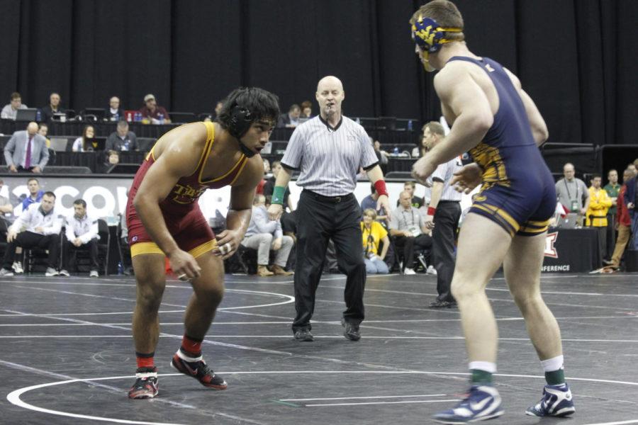 Redshirt sophomore Dane Pestano looks at West Virginias Jacob Scheffel to see how he can attack at the Big 12 Wrestling Championships in Kansas City on March 6. Pestano earned third place in the 184-pound weight class over the weekend.  