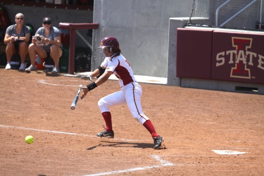 Outfielder Cathlin Bingham slaps the ball and lets go of her bat as she runs to first base on May 3, 2015.